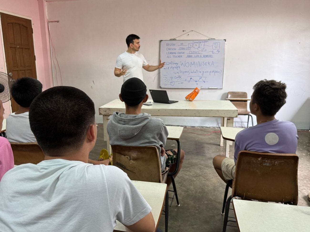 A class in progress, students working at laptops